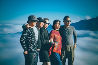 A happy family standing together on a scenic mountain trail during a group tour.