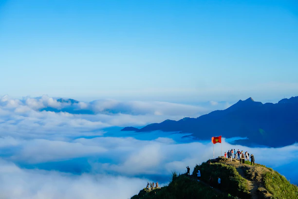 A group of tourists admiring a famous Vietnamese landmark with clear blue skies.