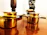Close-up of a polished brass kalash glowing softly in natural light.