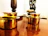 Close-up of a polished brass kalash glowing softly in natural light.