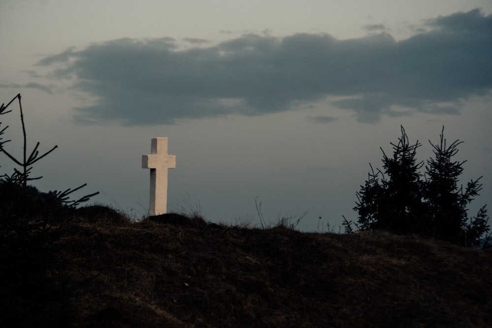 a white cross on a hill