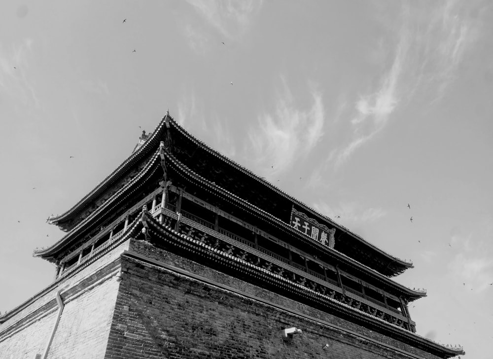 a black and white photo of a building with a sign on it