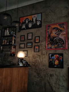 a wall with pictures and a lamp