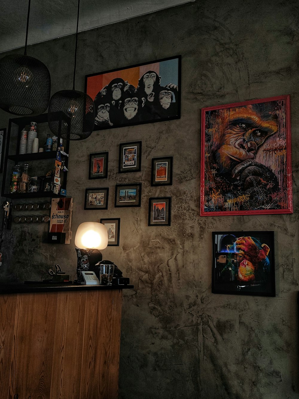 a wall with pictures and a lamp