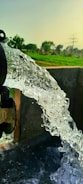 Close-up of water flowing clearly from a newly installed artesian well pump