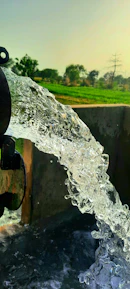 Close-up of clean water flowing from a well pipe.