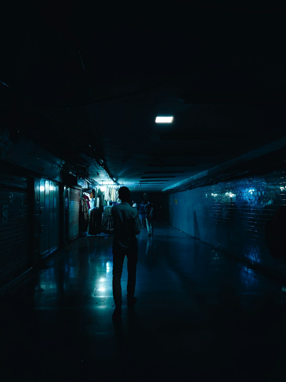 a person walking in a dark tunnel