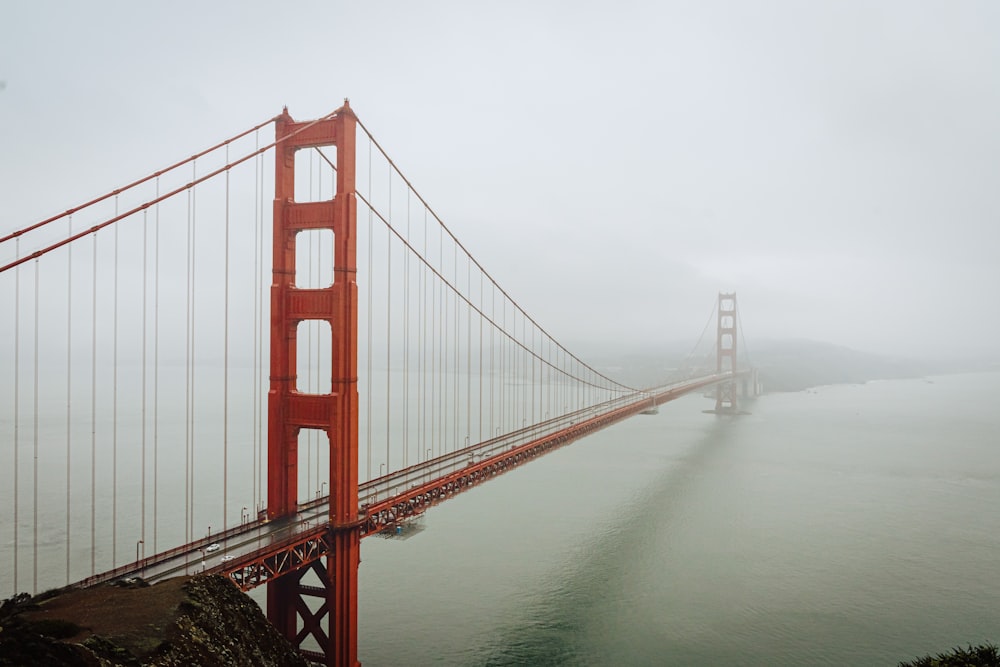 a large red bridge with Golden Gate Bridge in the background