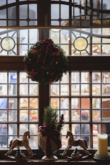 A beautifully decorated window with festive watercolor art.