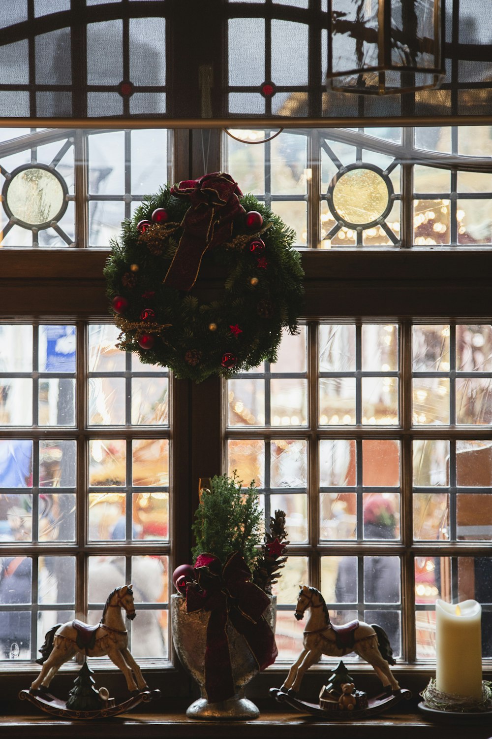 a group of statues sit in front of a window