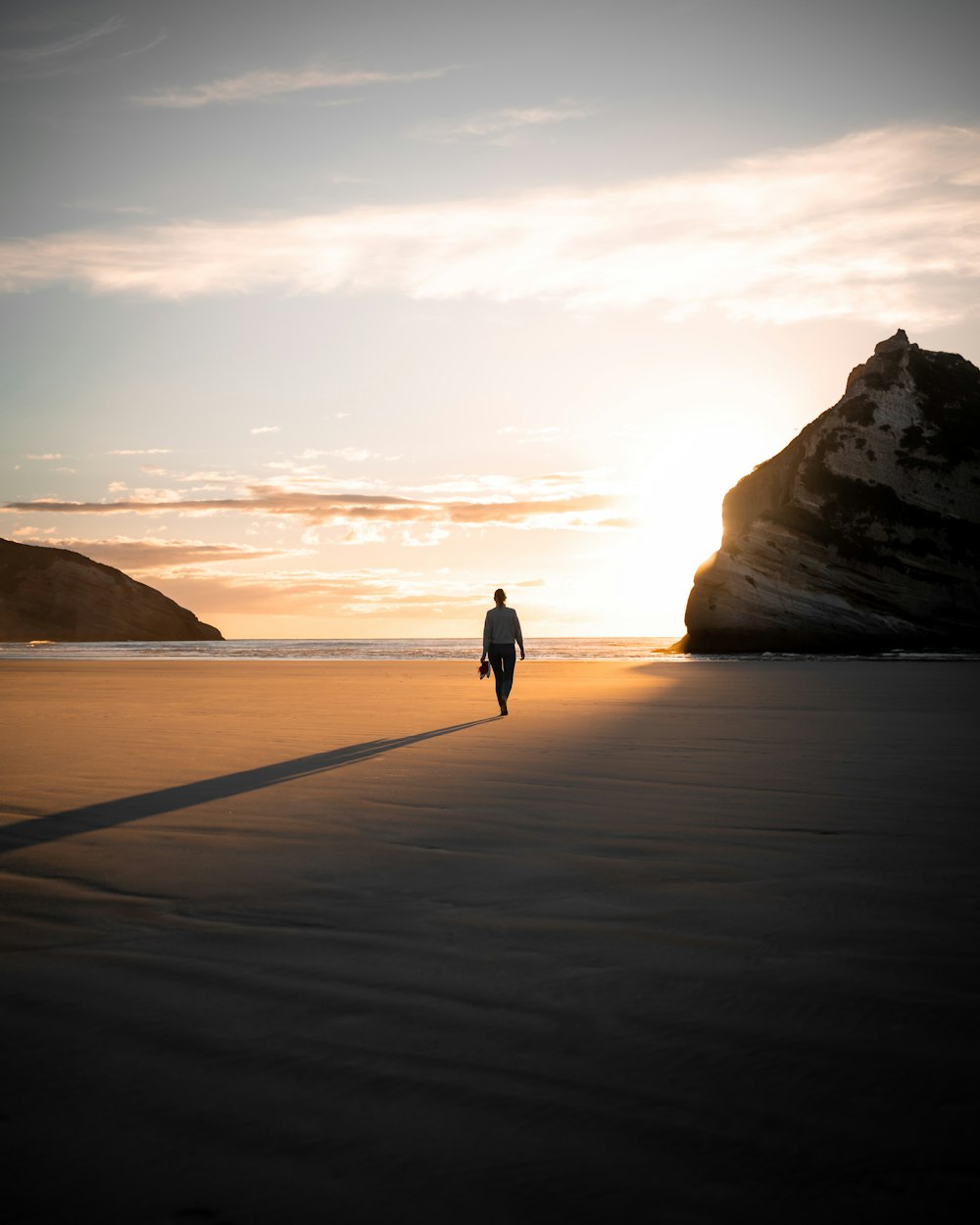 a person riding a bicycle on a beach