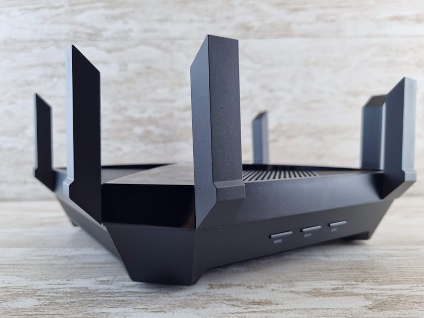 A sleek modem glowing with blue LED lights on a clean desk