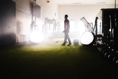 An instructor demonstrating a modality on a volunteer in a bright studio.