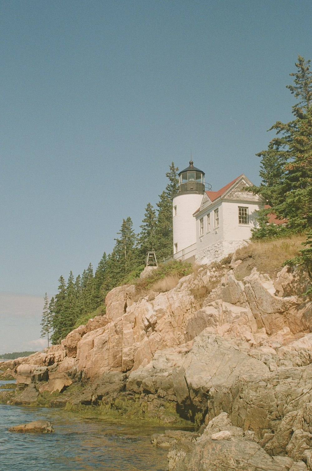 a white building on a rocky hill