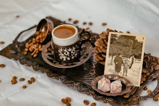 Traditional Arabic coffee setup with dates and elegant cups on a decorated table.