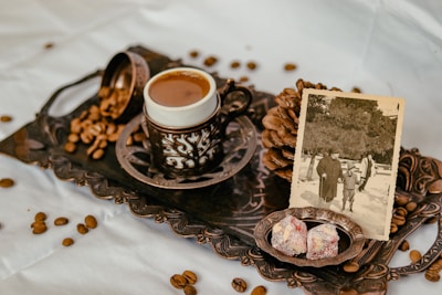 Traditional Arabic coffee setup with dates and elegant cups on a decorated table.