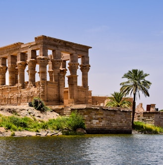 Philae with columns and a palm tree by a body of water
