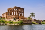 Philae with columns and a palm tree by a body of water
