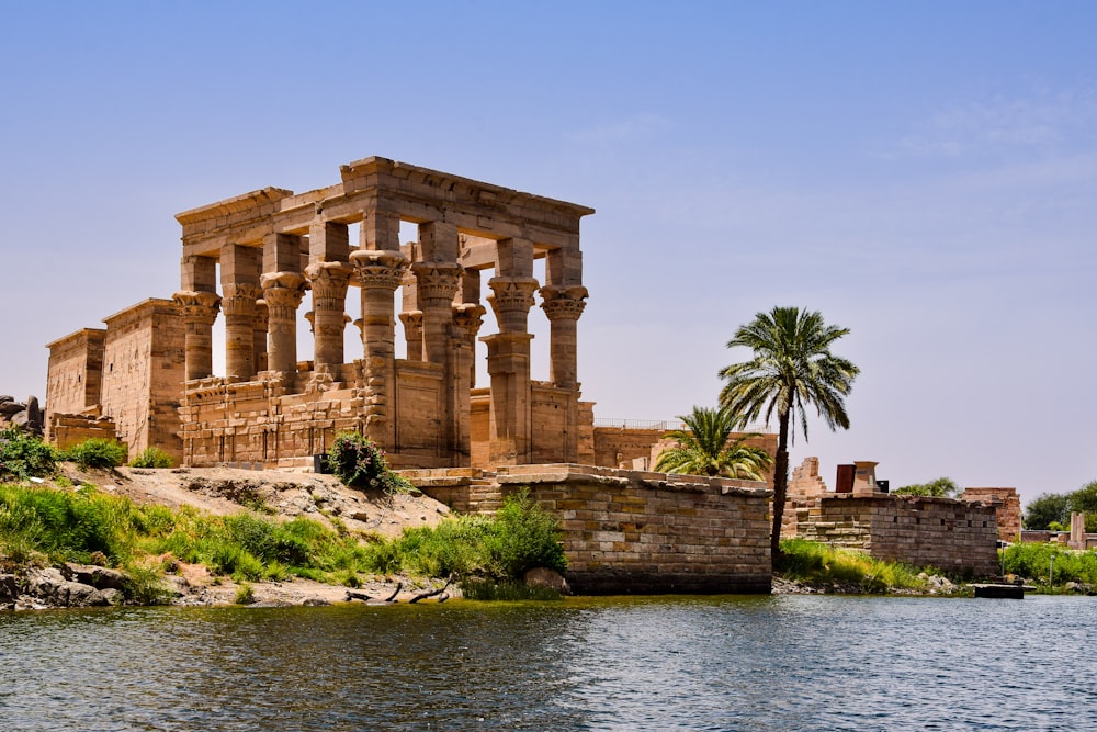Philae with columns and a palm tree by a body of water