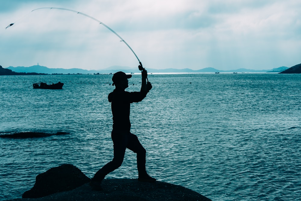 a man holding a fishing pole