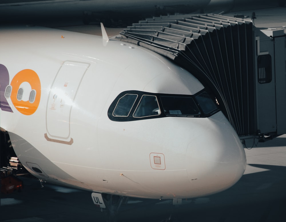 a white airplane in a hangar