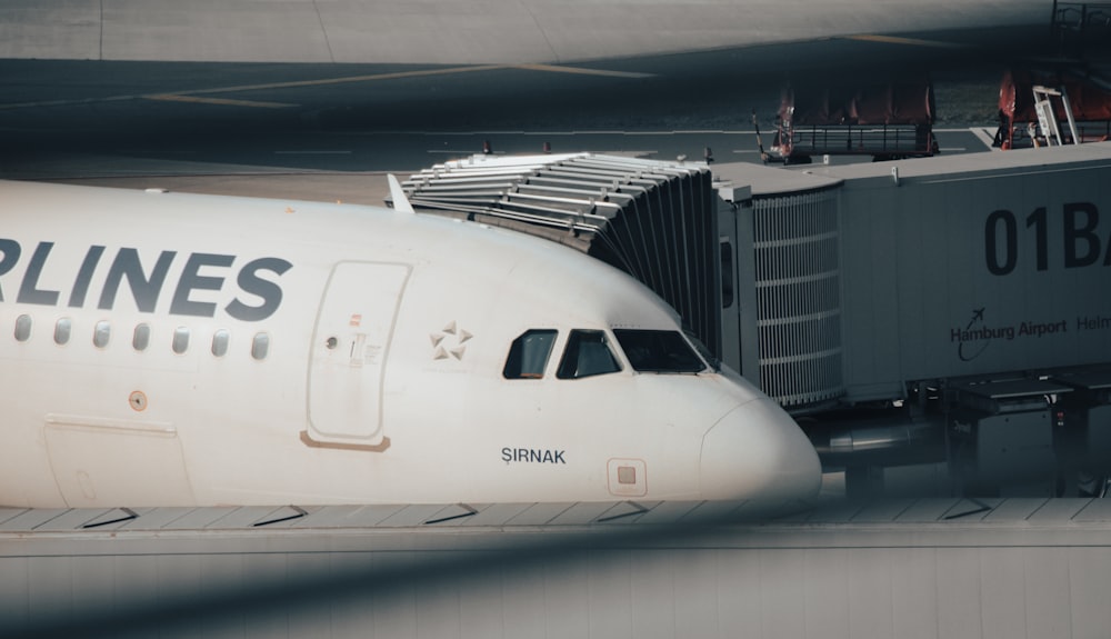 a large white airplane sits on a runway