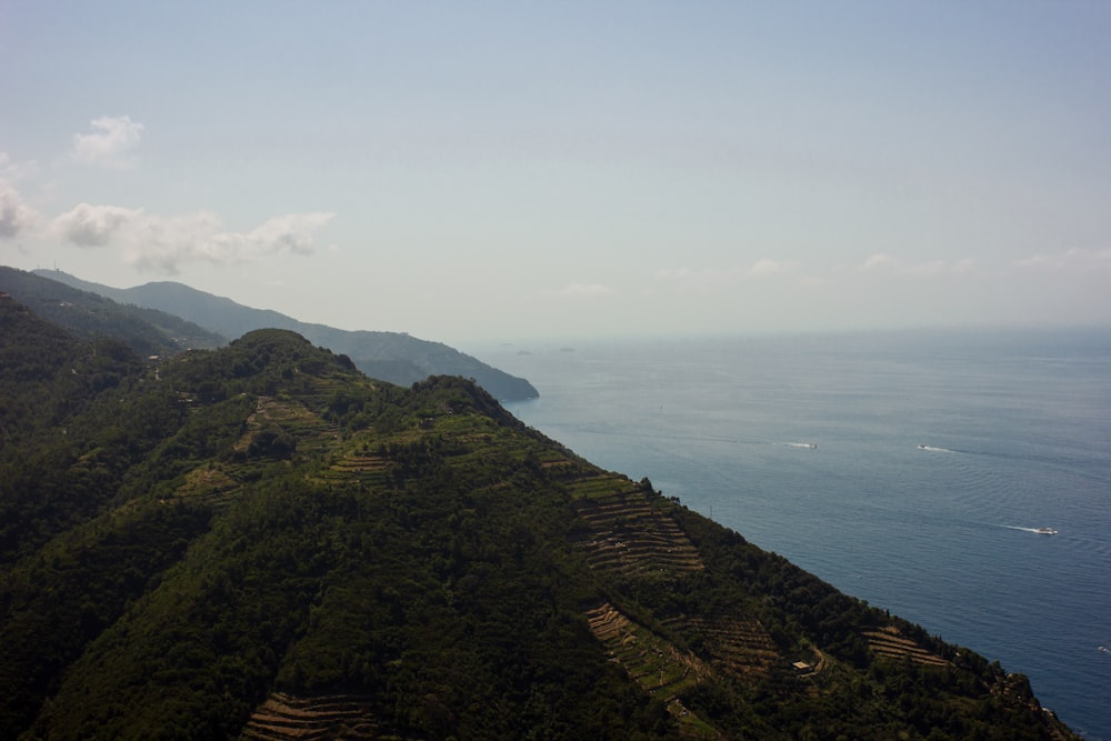 a hill with a body of water in the background