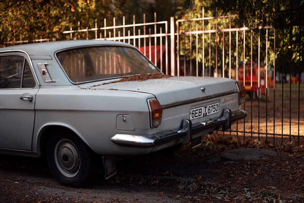 a white car parked on a gravel road