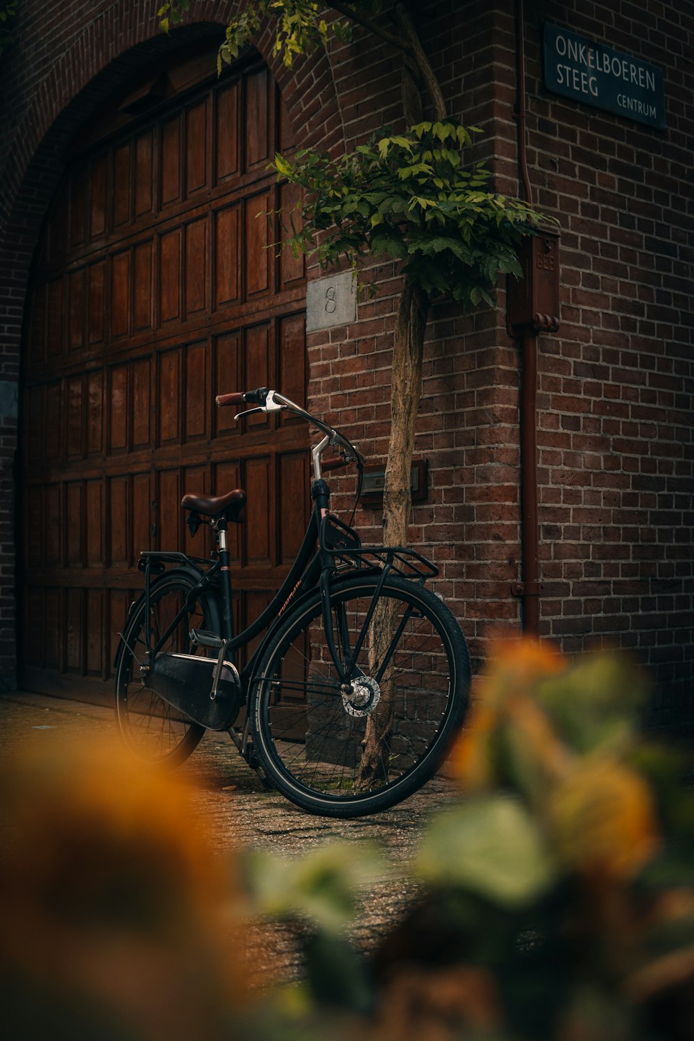 a bicycle parked in front of a brick building