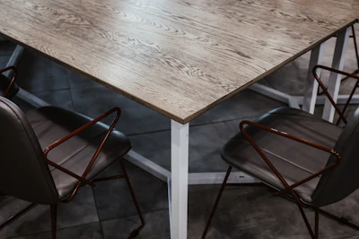 A sleek modern glass dining table paired with minimalist metal chairs.