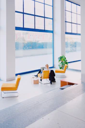 a room with a window and chairs