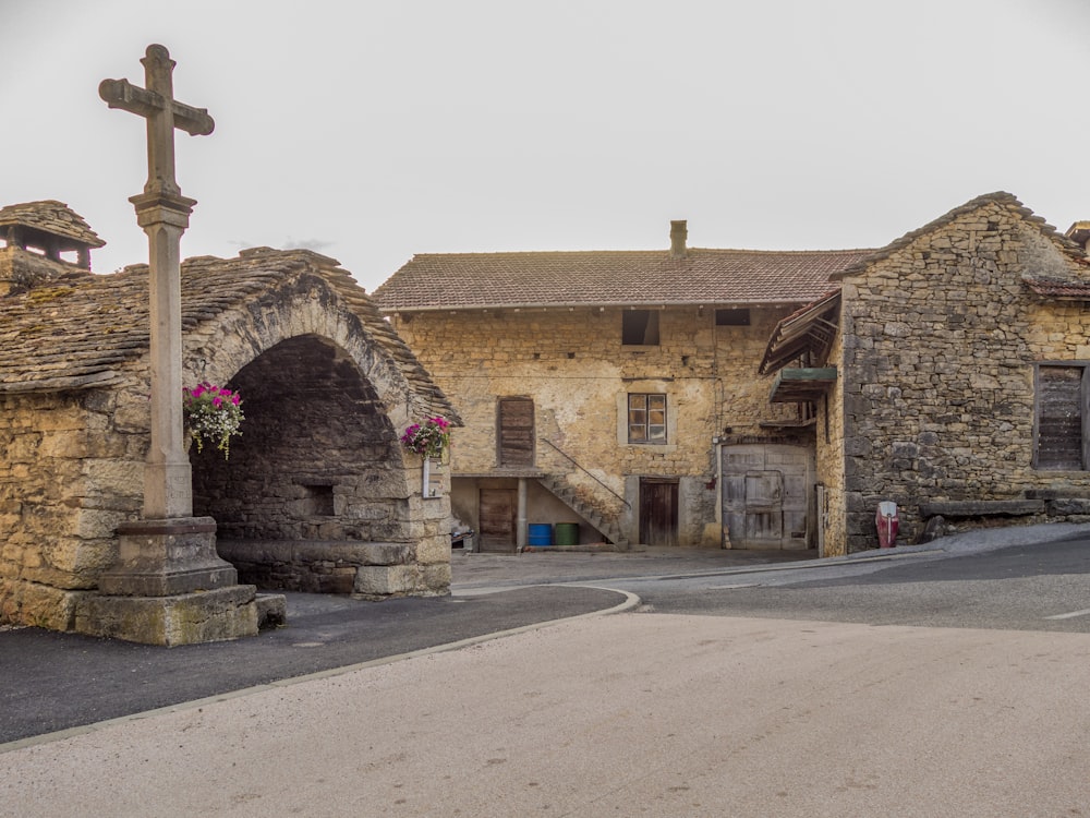 a stone building with a cross on top