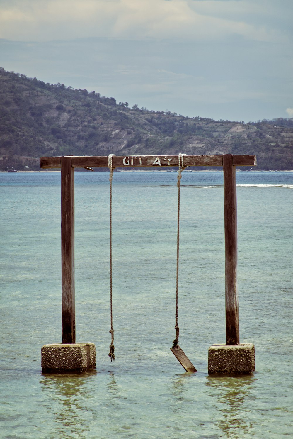 a group of wooden poles in the water