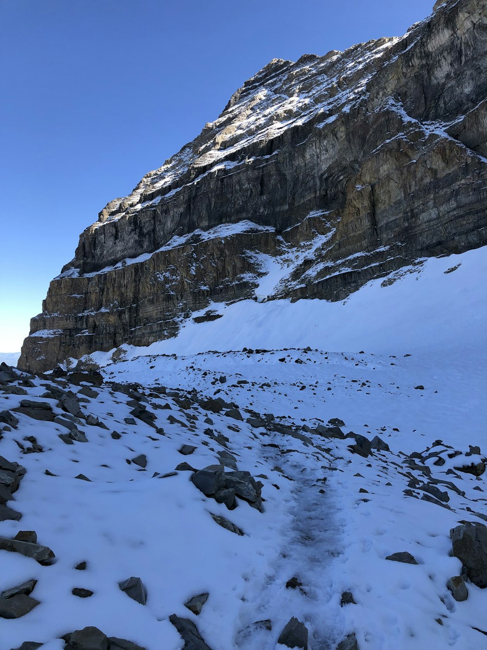 a snowy mountain with rocks