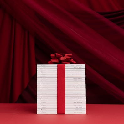 A stack of beautifully bound books tied with a ribbon, ready to be gifted.