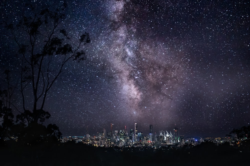 a city at night with lightning striking the ground