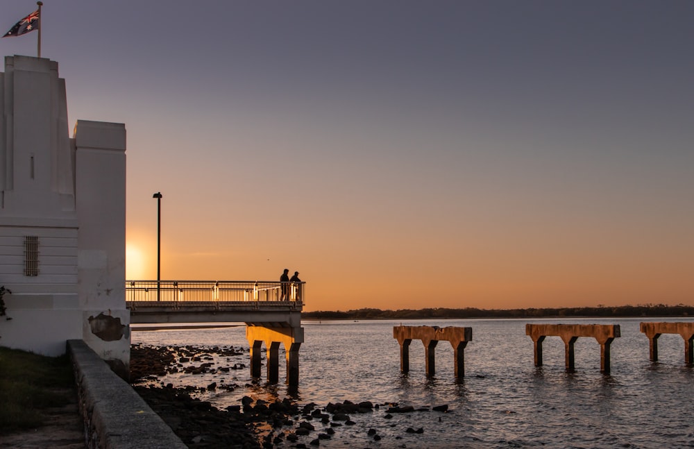 a pier with a building and a flag on it