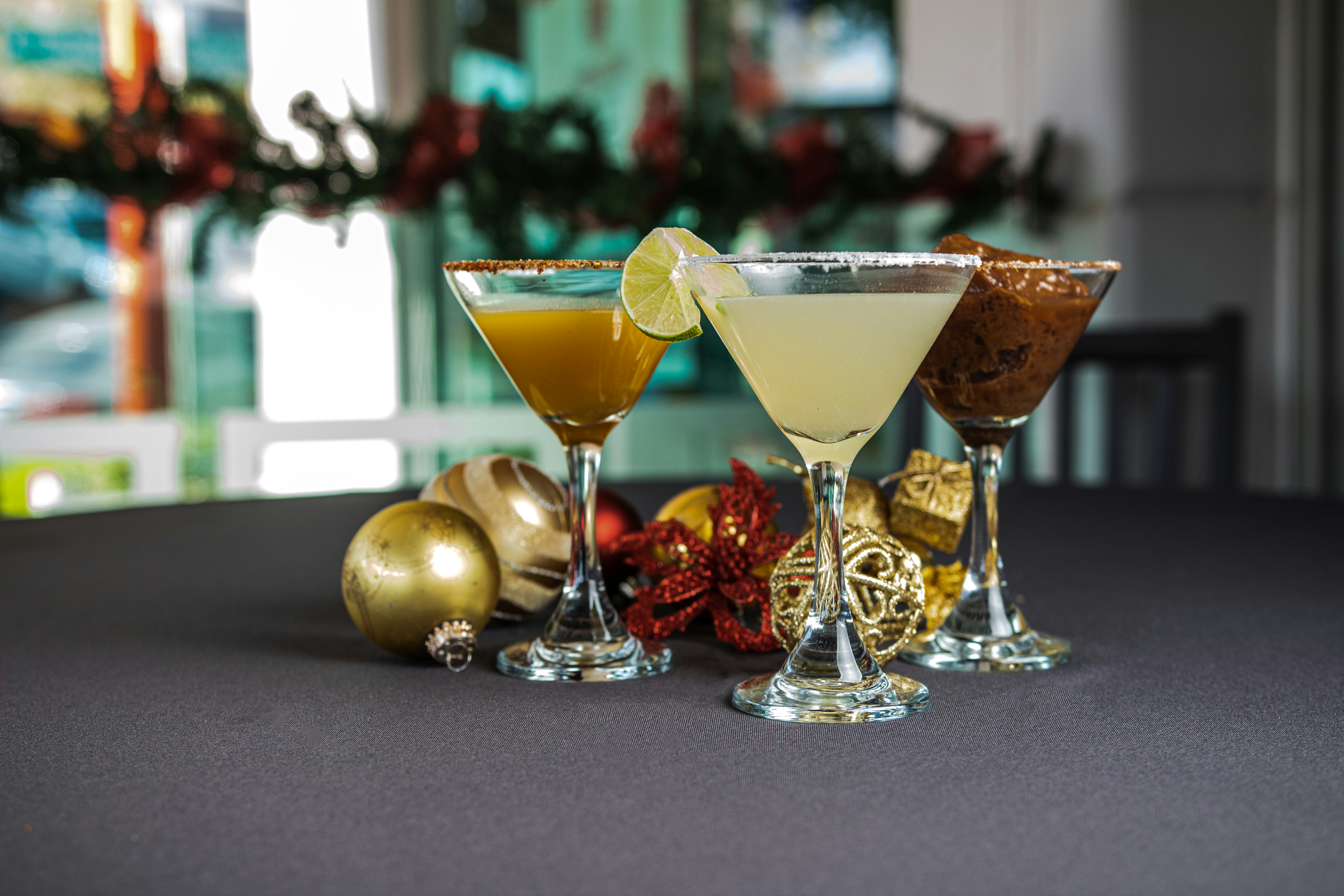 a group of glasses with drinks in them