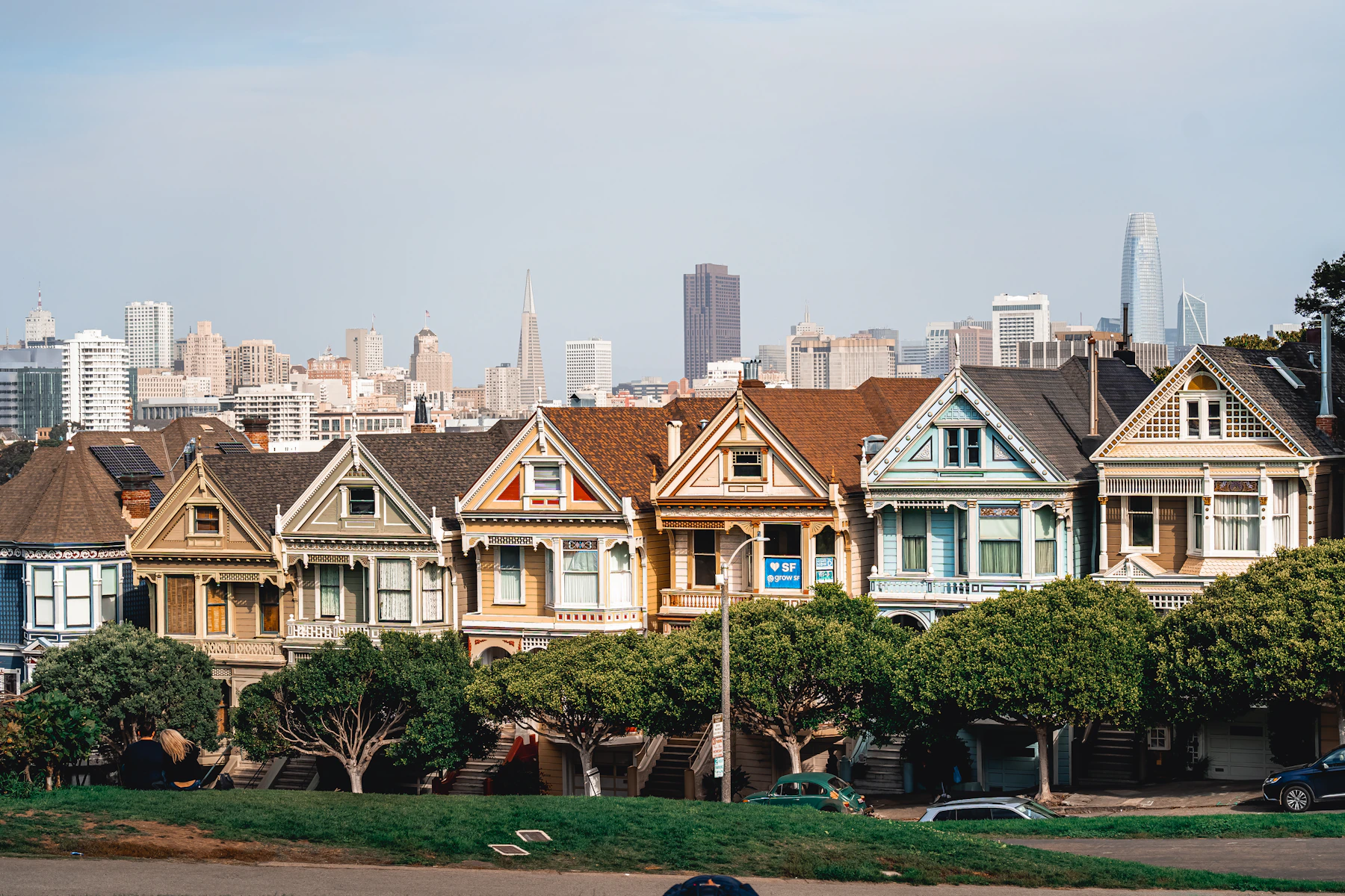 Row of San Francisco Victorian houses with the city skyline behind them