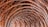 Intricately woven arches made from bamboo create a textured, layered pattern that gives the impression of depth and repetition. The natural material and craftsmanship showcase a blend of traditional techniques with a modern architectural style.