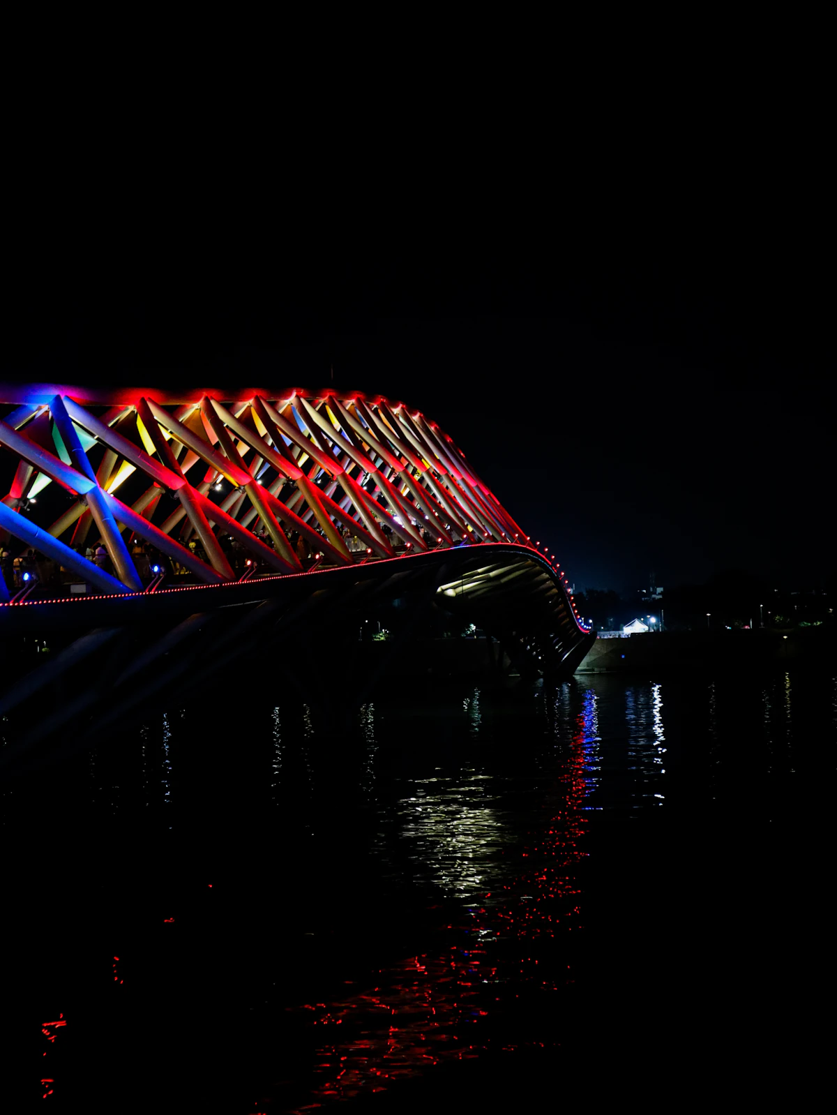 Atal Bridge illuminated at night over the Sabarmati Riverfront in Ahmedabad