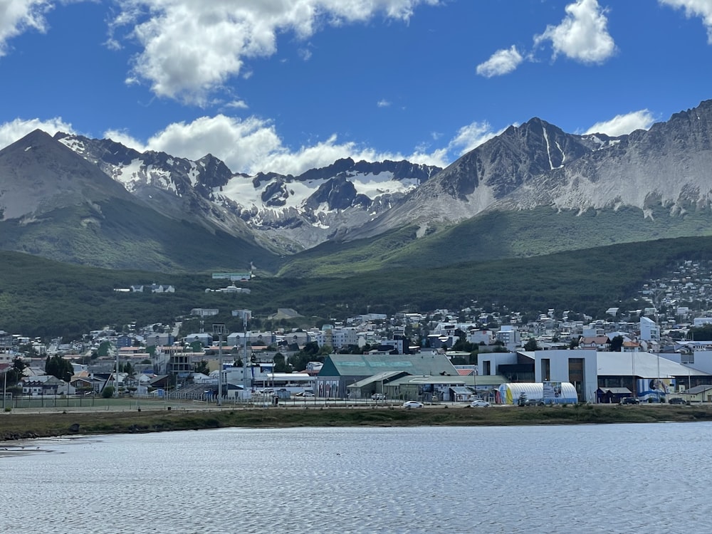 a town by a lake with mountains in the background
