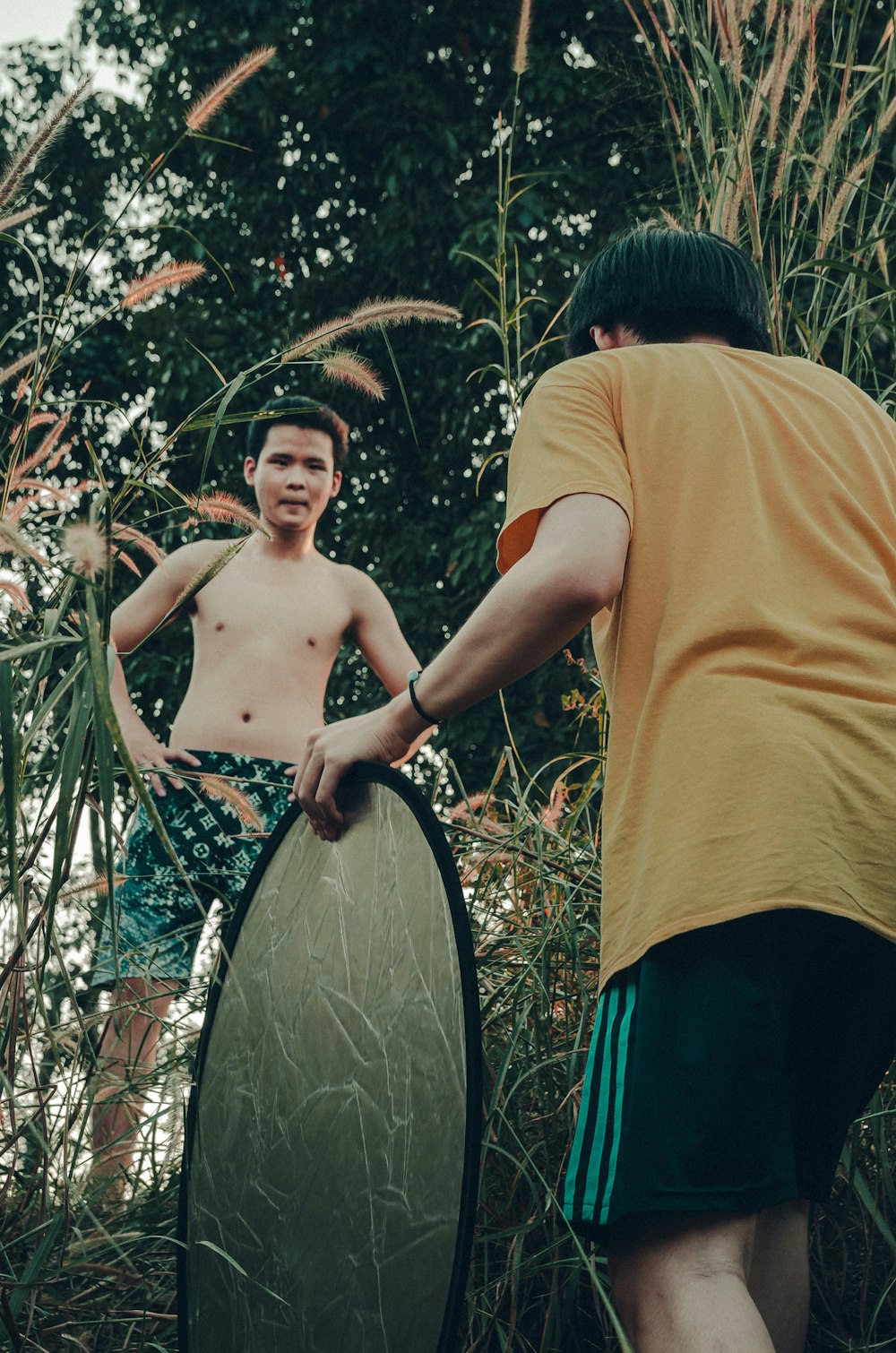 a couple of boys holding a fish