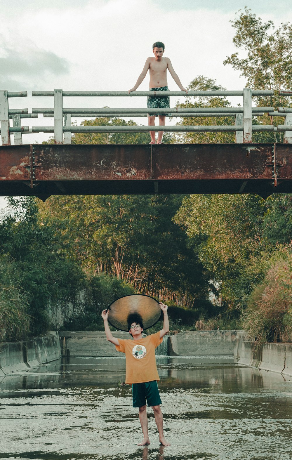 a person and a boy jumping into a pool of water