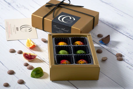 An elegant box of assorted chocolates with rich brown and gold packaging, inviting and luxurious.