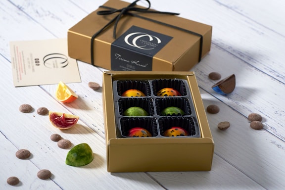 A vibrant display of assorted chocolates and cacao pods on a rustic table.