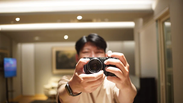 Behind-the-scenes glimpse of Shyra setting up her camera for a TikTok video in her calm, stylish home.