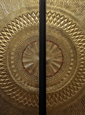 An elegant yantra design illuminated with gold accents.