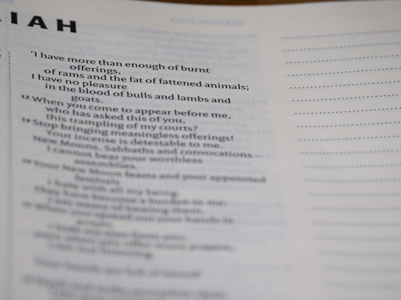 A close-up photo of a page from a book with text in paragraphs. The visible text includes words related to religious offerings, animals like rams and goats, and mentions of incense.