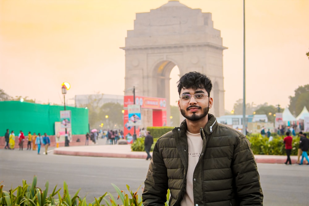 a man standing in front of a monument